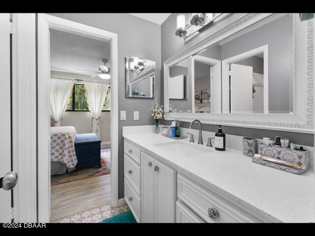 bathroom with ceiling fan and vanity