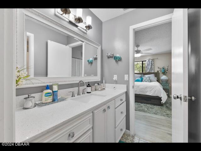 bathroom with vanity, a textured ceiling, and ceiling fan