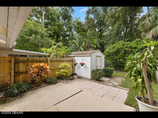 view of patio / terrace with a shed