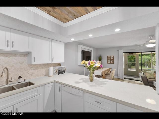 kitchen featuring white cabinetry, white dishwasher, and kitchen peninsula