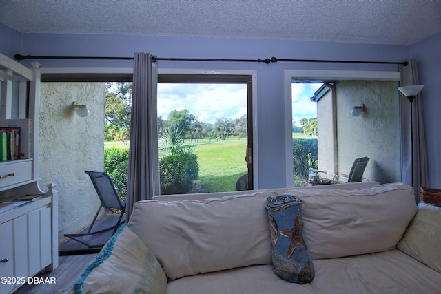 219 Club House Blvd Unit 219, New Smyrna Beach, FL 32168 - bedroom with multiple windows, wood finished floors, and a textured ceiling