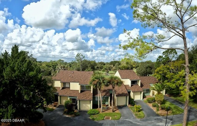 219 Club House Blvd Unit 219, New Smyrna Beach, FL 32168 - view of front of house with asphalt driveway, a garage, and stucco siding