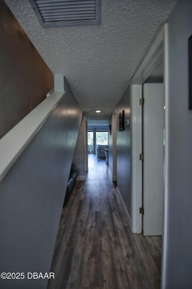 219 Club House Blvd Unit 219, New Smyrna Beach, FL 32168 - hallway featuring wood finished floors, a textured ceiling, and baseboards