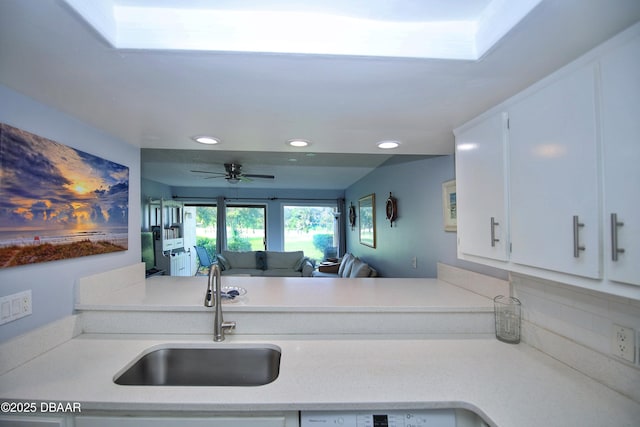 219 Club House Blvd Unit 219, New Smyrna Beach, FL 32168 - kitchen with a sink, light countertops, recessed lighting, white cabinets, and ceiling fan
