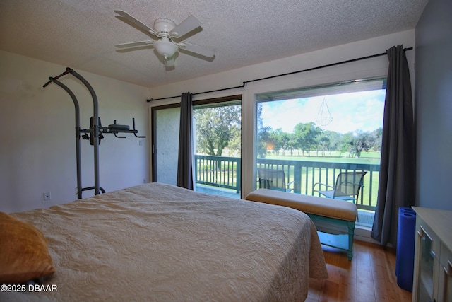 219 Club House Blvd Unit 219, New Smyrna Beach, FL 32168 - bedroom featuring access to outside, light wood-style floors, a textured ceiling, and a ceiling fan