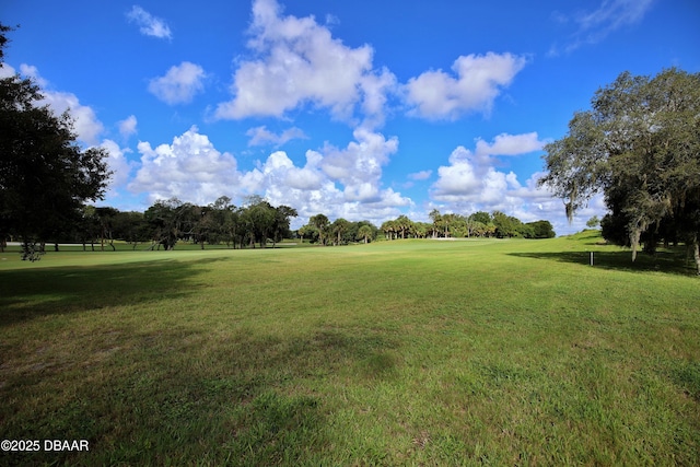 219 Club House Blvd Unit 219, New Smyrna Beach, FL 32168 - view of home's community with a yard, golf course view, and view of wooded area