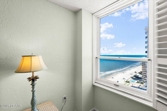 2987 S Atlantic Ave Unit Q020, Daytona Beach, FL 32118 - interior space featuring view of water and beach, a textured ceiling, and multiple windows