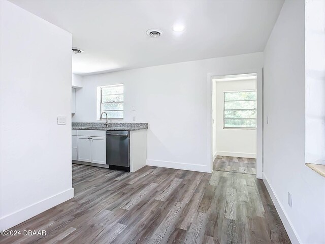 kitchen featuring dishwasher, white cabinets, and light hardwood / wood-style flooring