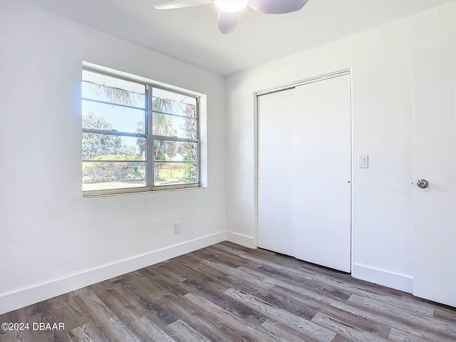 unfurnished bedroom with a closet, hardwood / wood-style floors, and ceiling fan