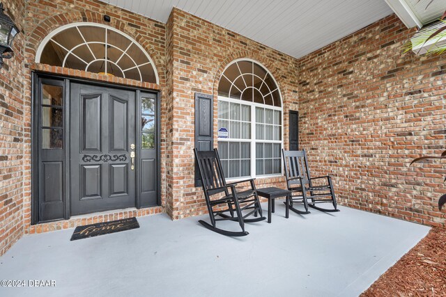 view of exterior entry featuring a porch