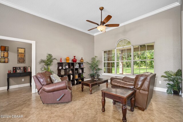 tiled living room with a textured ceiling, ceiling fan, and crown molding