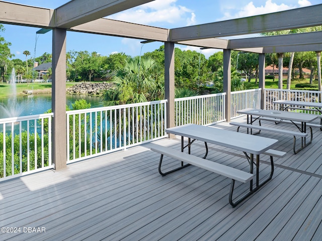 wooden terrace featuring a water view