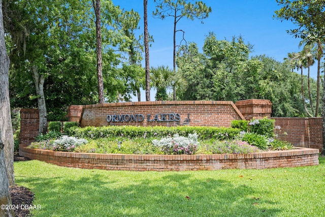 community / neighborhood sign featuring a yard