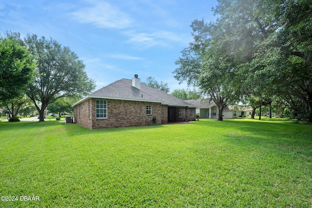 rear view of house with a lawn