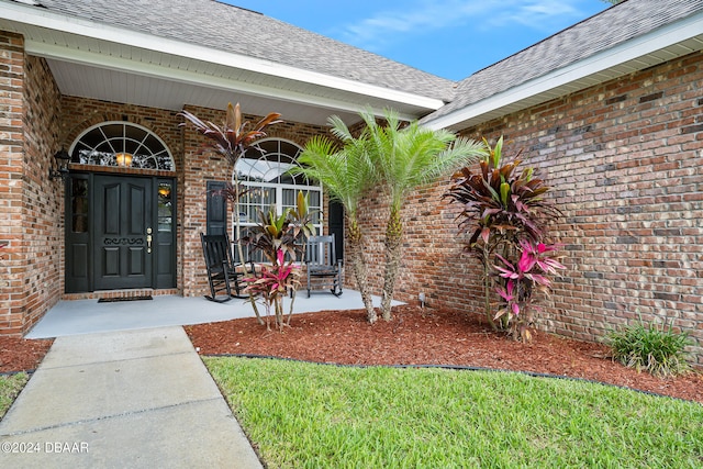 view of exterior entry featuring a porch