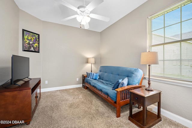 sitting room featuring light colored carpet and ceiling fan