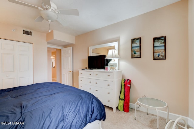 bedroom with light colored carpet, a closet, and ceiling fan