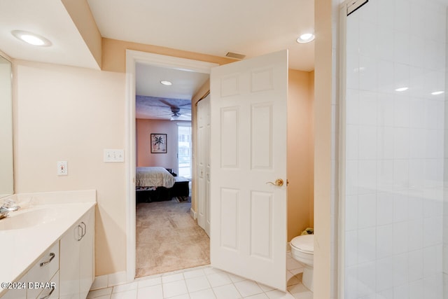 bathroom with tile patterned flooring, vanity, toilet, and ceiling fan