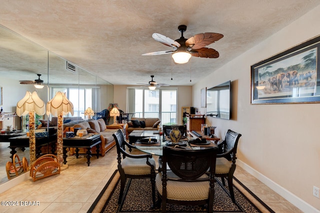 tiled dining space with a textured ceiling