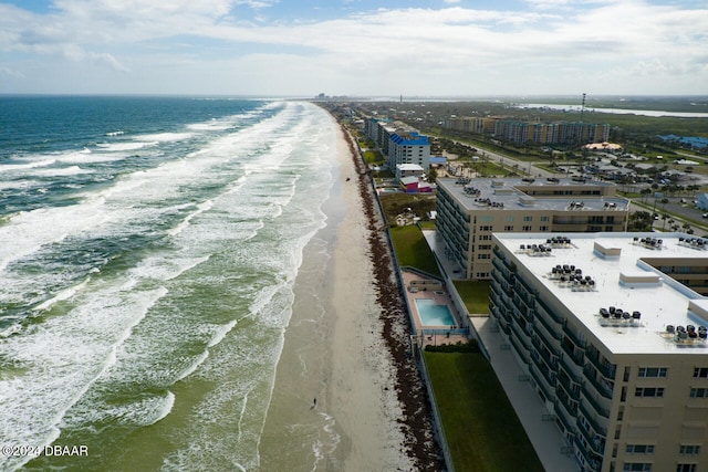 drone / aerial view with a water view and a beach view