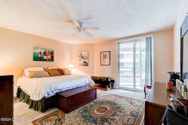 bedroom with access to exterior, ceiling fan, carpet, and a textured ceiling