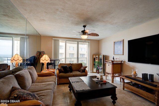 tiled living room with a textured ceiling, ceiling fan, and a healthy amount of sunlight