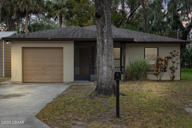 ranch-style house featuring a front yard and a garage