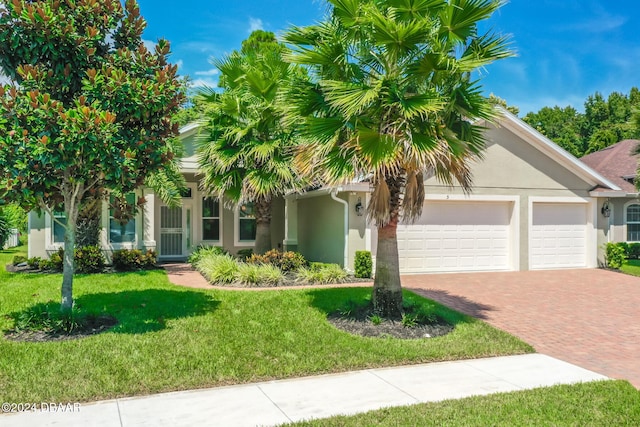 view of front of house with a front yard and a garage