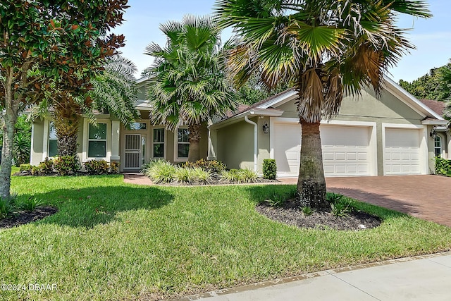 single story home with a front yard and a garage