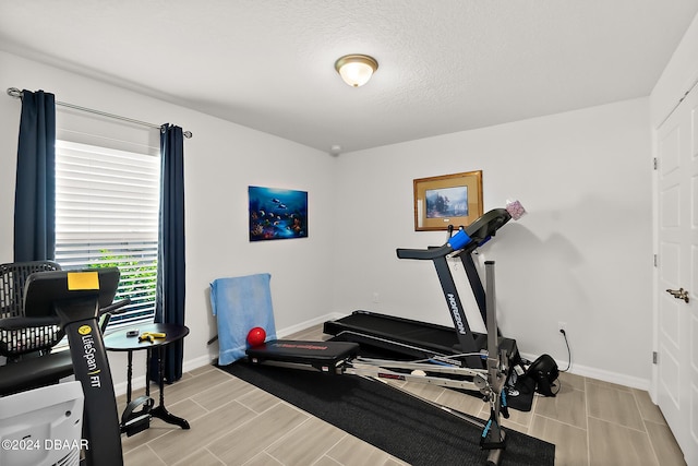 workout room with a textured ceiling