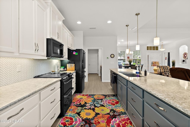 kitchen featuring sink, hanging light fixtures, gray cabinets, white cabinets, and black appliances