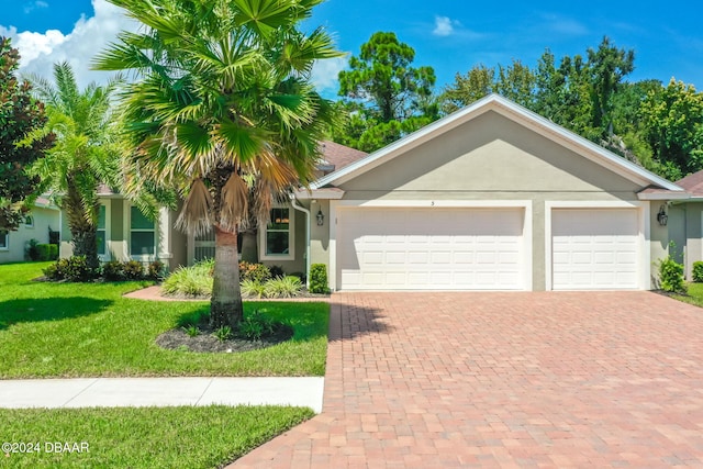 single story home with a front lawn and a garage