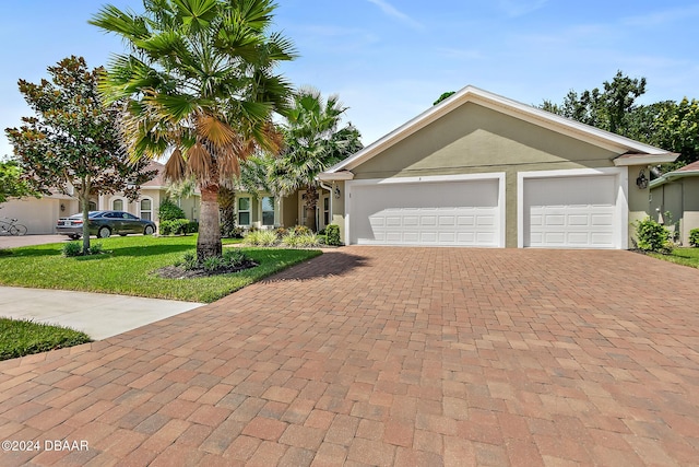 view of front of property with a garage and a front yard