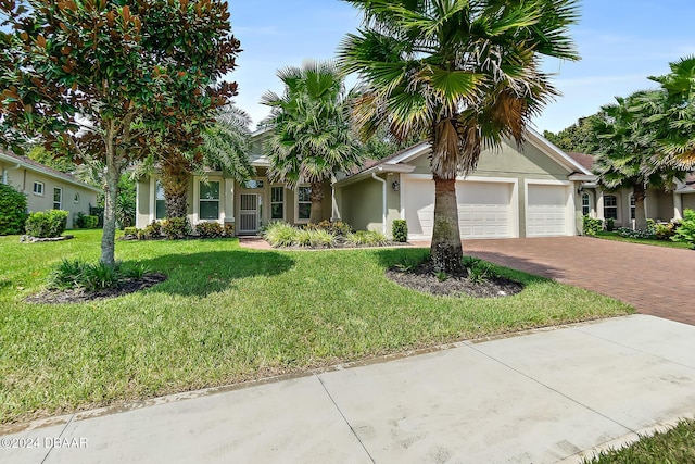 single story home featuring a garage and a front lawn