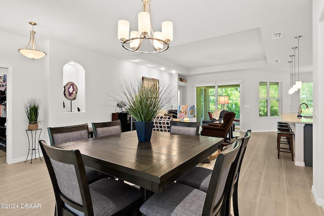 dining area with an inviting chandelier and sink