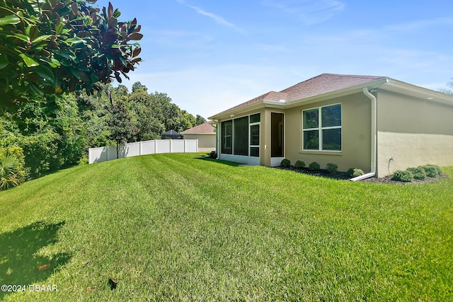 view of yard with a sunroom