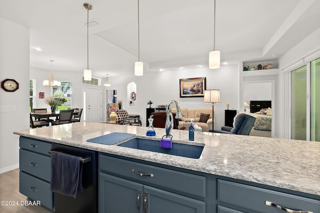 kitchen featuring hanging light fixtures, plenty of natural light, and sink