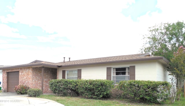 ranch-style house featuring a garage