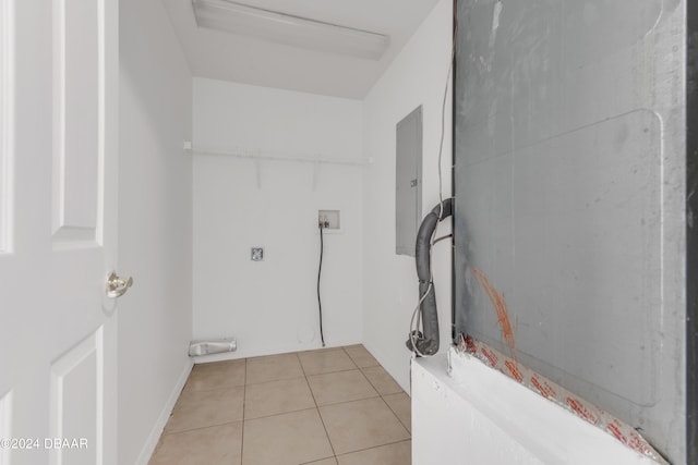 washroom with hookup for an electric dryer, electric panel, hookup for a washing machine, and light tile patterned floors