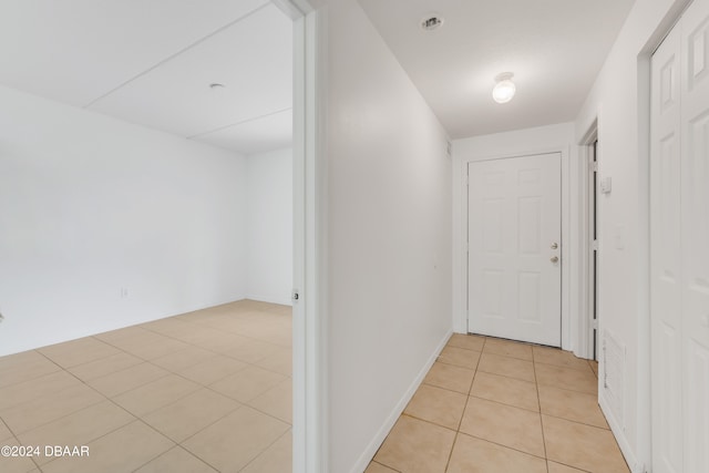 corridor with light tile patterned floors