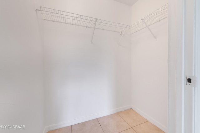 spacious closet with light tile patterned floors