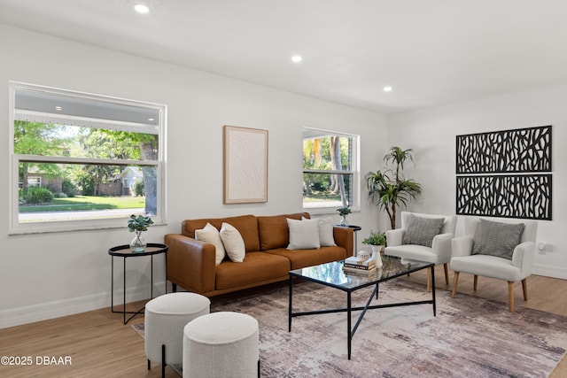 living area featuring recessed lighting, baseboards, and wood finished floors