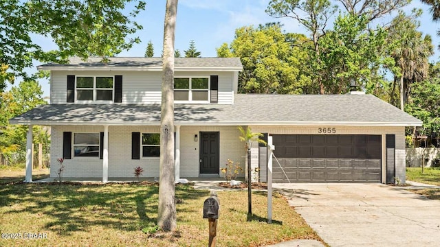 traditional-style home featuring roof with shingles, a front lawn, brick siding, an attached garage, and concrete driveway
