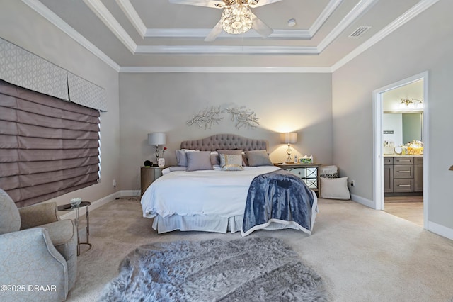 bedroom with a raised ceiling, ornamental molding, light carpet, and ensuite bath