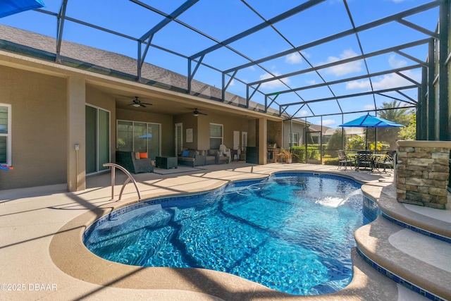 view of pool with pool water feature, a lanai, ceiling fan, an outdoor living space, and a patio area