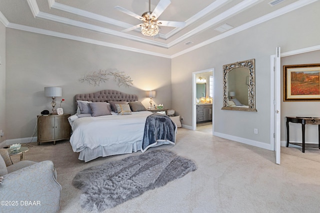 carpeted bedroom with crown molding, ceiling fan, a raised ceiling, and ensuite bath