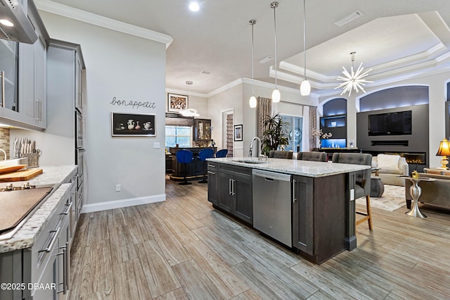 kitchen with a chandelier, dishwasher, an island with sink, and hanging light fixtures