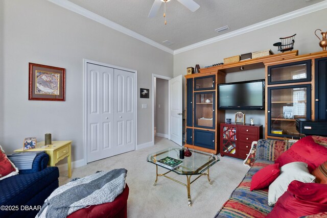 carpeted living room with ceiling fan, ornamental molding, and a textured ceiling