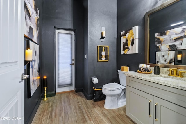 bathroom with vanity, hardwood / wood-style flooring, and toilet