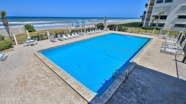 5499 S Atlantic Ave Unit 104, New Smyrna Beach, FL 32169 - community pool with a water view, a patio, fence, and a view of the beach